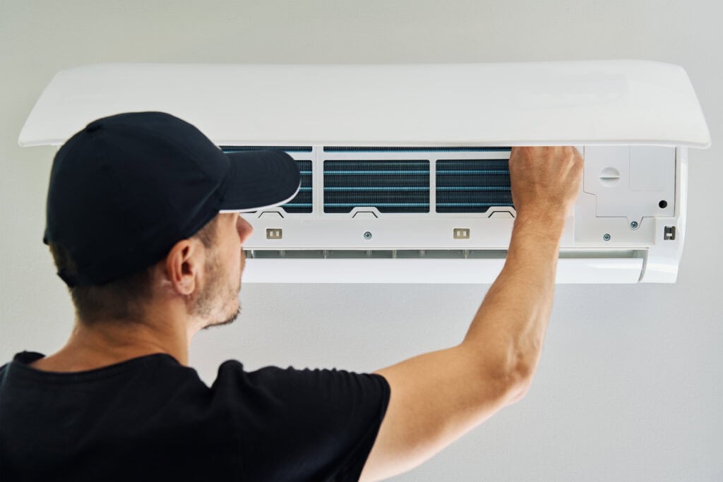 Wortham Air Conditioning - Man Repairing AC Indoor Unit