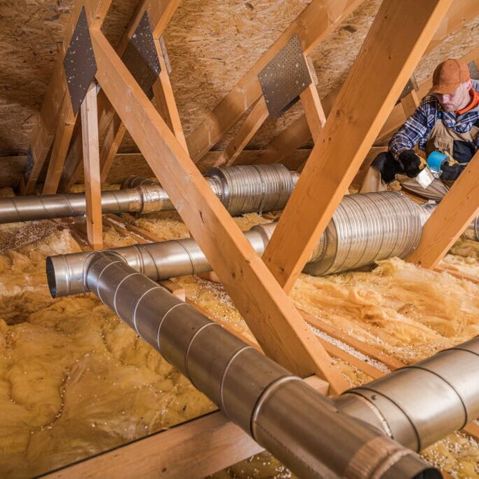 Wortham Air Conditioning - Attic Worker Repairing Ventilation System