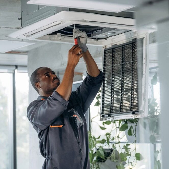 Wortham Air Conditioning - Repairman fixing ventilation