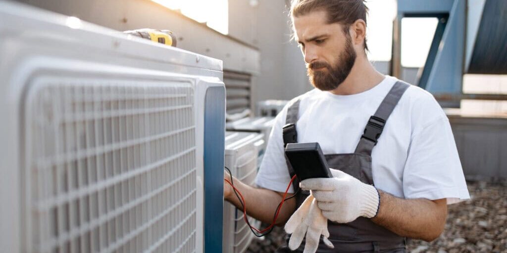 Wortham Air Conditioning - Man Inspecting AC Unit