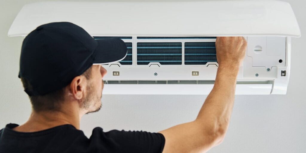 Wortham Air Conditioning - Man Repairing AC Indoor Unit