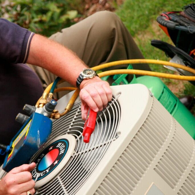 Wortham Air Conditioning - Man Fixing AC Unit