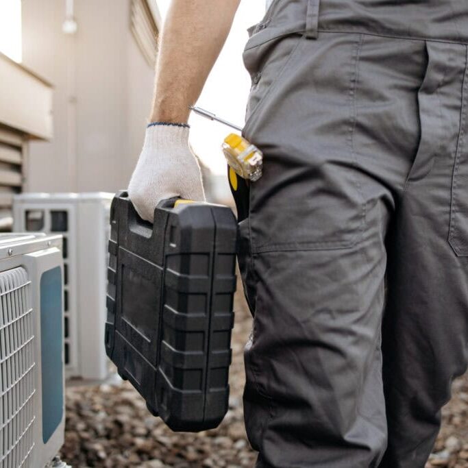Wortham Air Conditioning - Repairman Working on AC